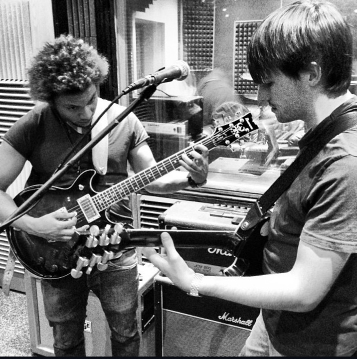 Brad Songhurst playing guitar in the studio