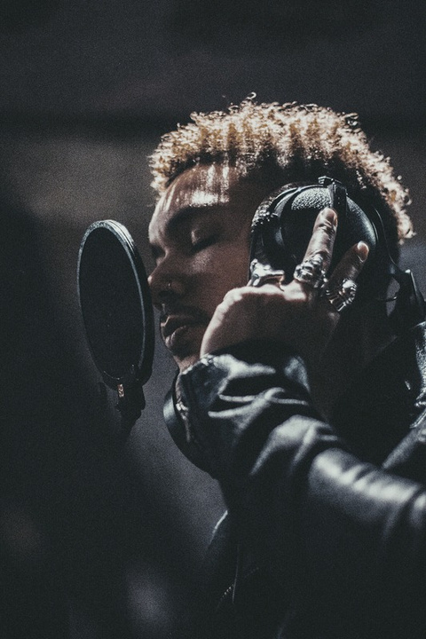 Brad Songhurst singing into a microphone